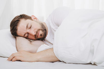 Young woman lying on bed at home