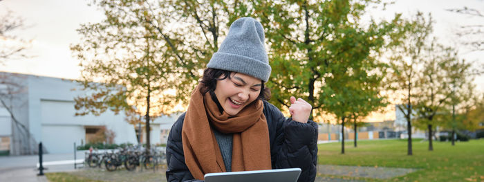 Portrait of young woman using mobile phone