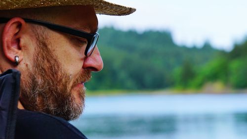 Close-up of man wearing eyeglasses looking away