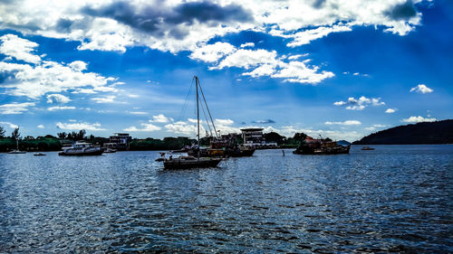 Sailboats in sea against sky