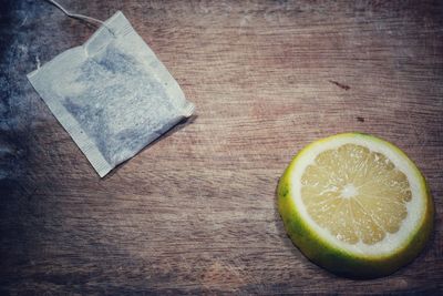 High angle view of lemon and teabag on table