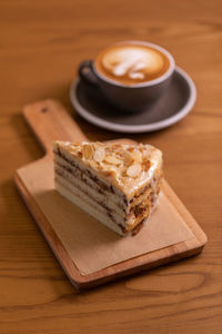 Coffee cup and cake on table