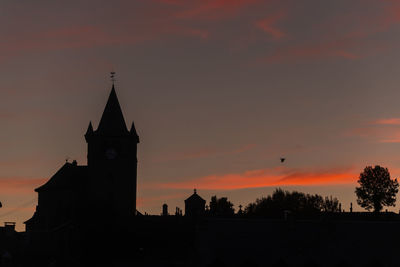 Low angle view of silhouette cathedral against sky during sunset