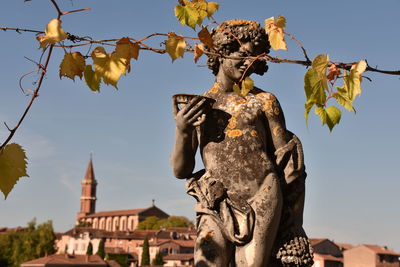 Low angle view of statue against sky