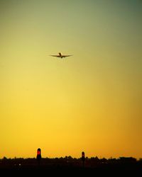 Hot air balloon flying in sky at sunset