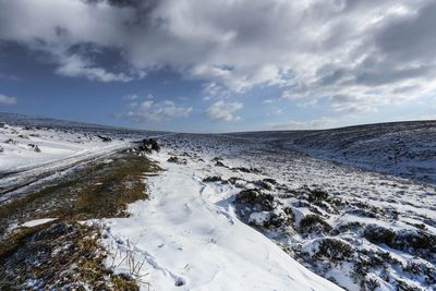 Scenic view of snow covered dartmoor against sky