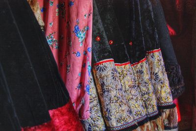 Close-up of clothes hanging in market for sale