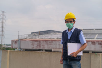 Portrait of engineer standing in factory