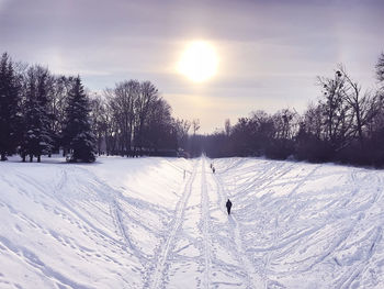 Scenic view of snow covered field against sky