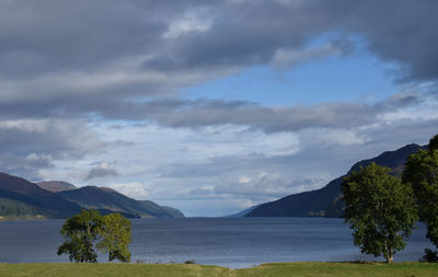 Scenic view of lake and mountains against sky