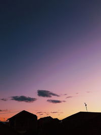 Silhouette buildings against sky during sunset