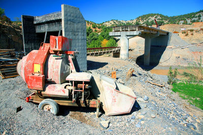 Construction machinery with bridge in background