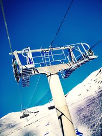 Overhead cable car against blue sky