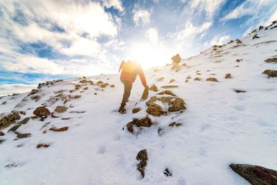 Woman standing on snow covered landscape