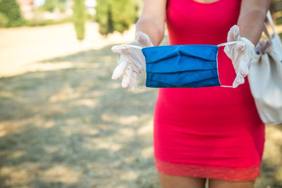 Midsection of woman holding umbrella