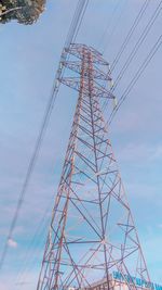 Low angle view of electricity pylon against sky