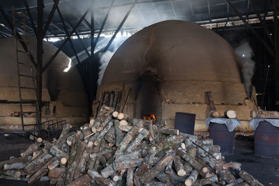Smoke emitting from kiln by logs in industry