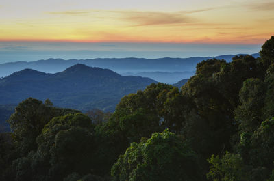 Scenic view of mountains against sky at sunset