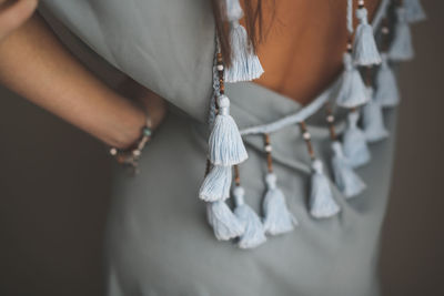 Woman trying on a tunic for the beach, concept of vacation fees, a handmade fringed tunic for sea