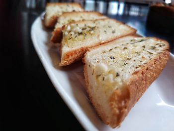 Close-up of breads in plate on table