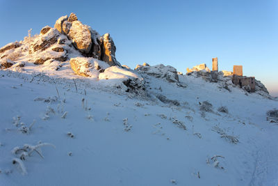 Scenic view of snowcapped mountains against clear blue sky