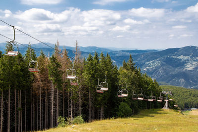 Panoramic view of trees and mountains against sky