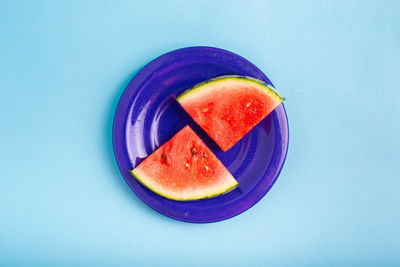 Directly above shot of fruit in plate against white background