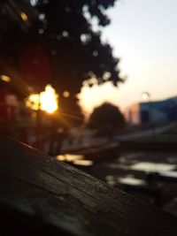 Close-up of railroad track against sky during sunset