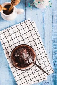 Homemade sweet cake in a mug made in the microwave on the table top and vertical view