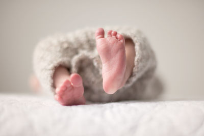 Close-up of baby legs on bed