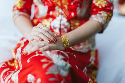 Midsection of woman with red umbrella