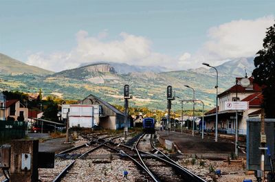 Railroad tracks against mountains