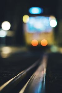 Defocused image of illuminated city street at night