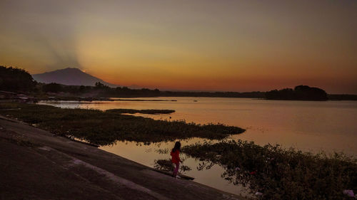 Scenic view of lake against sky during sunset