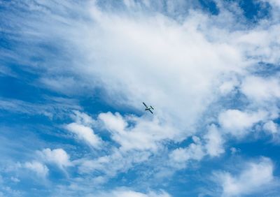 Low angle view of airplane flying in sky