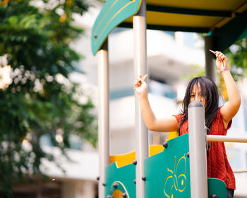 Cheerful girl standing at playground