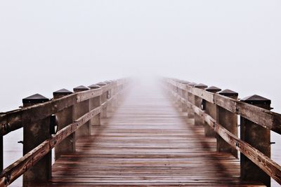 Empty footbridge in foggy weather