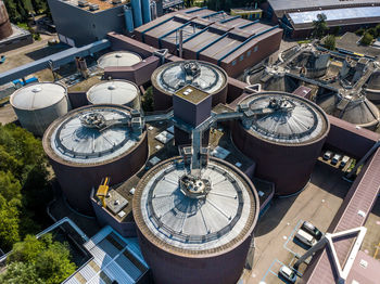 High angle view of industrial buildings in city during sunny day