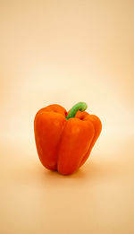 Close-up of red bell pepper against yellow background