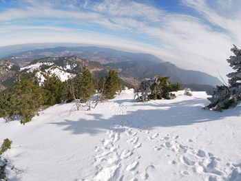 Scenic view of snowcapped mountains against sky