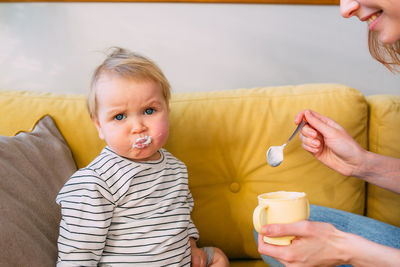 Portrait of cute boy eating food at home