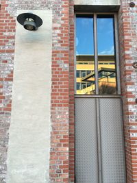 Low angle view of window on brick wall