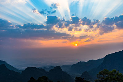 Scenic view of silhouette mountains against sky during sunset