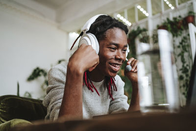 Happy freelancer wearing headset at home office