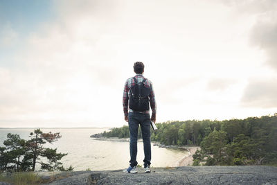 Rear view of man standing against sky