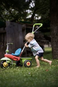 Boy playing with toy on field