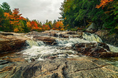Water flowing through rocks during autumn