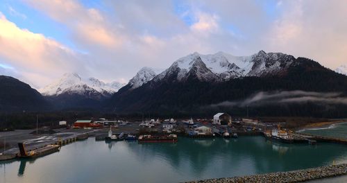 Scenic view of lake and snowcapped mountains against sky