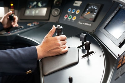 Cropped image of man driving train