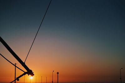 Low angle view of silhouette street light against sky during sunset